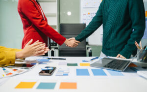 Handshake across the table as professionals align on a successful direct marketing strategy.